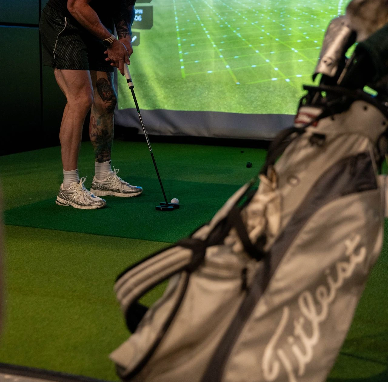 Golfer playing at Green Bird indoor golf simulator in Flower Mound, TX